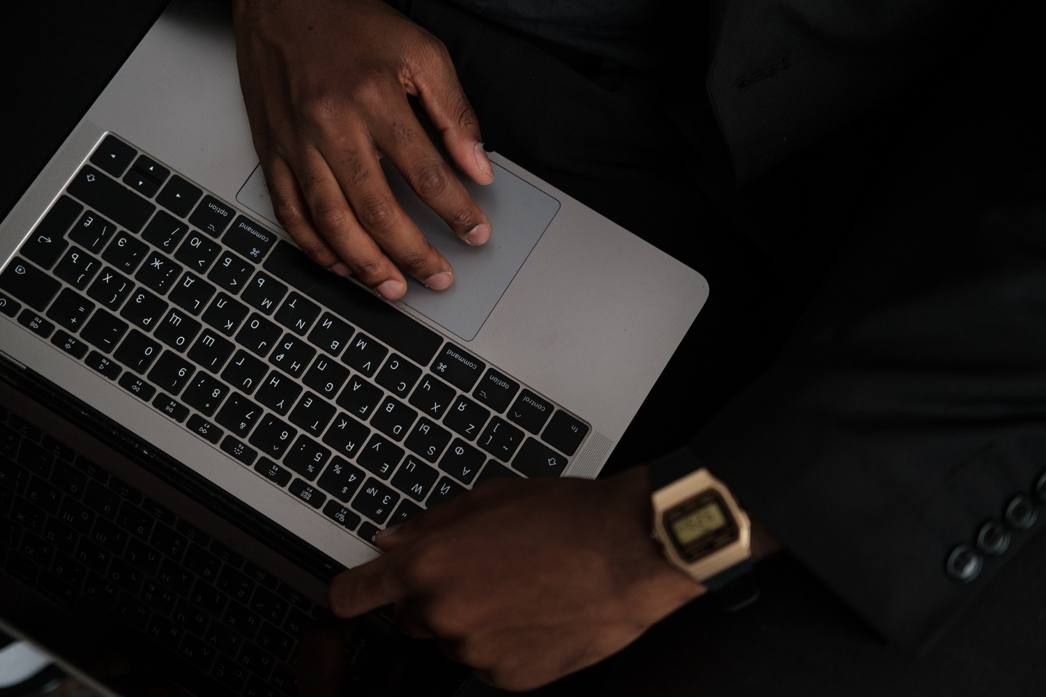 Man Typing on Laptop